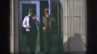 Kansas (1958): Two Men Wearing Jackets And Caps Leaving A Building And Smoking