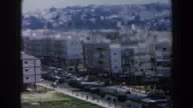 Israel (1960): Vehicular Traffic Uses A Busy Street In Front Of A Cluster Of