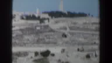 Israel (1960): Passing View Of White Tower And Trees On A Sunny Day