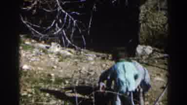 Israel-1960: Two Children Squat And Dig In The Soil Near A Stone Wall In The