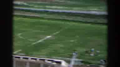 Israel (1960): Group Of Men Play Soccer In A Natural Grass Field Around People