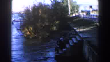 Israel (1960): A River Current Flows Past Some Steps Near A Road With Mountains