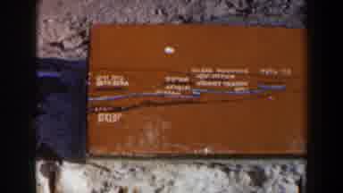 Israel (1960): An Orange-Colored Box With White Lettering Sits On The Ground Amid