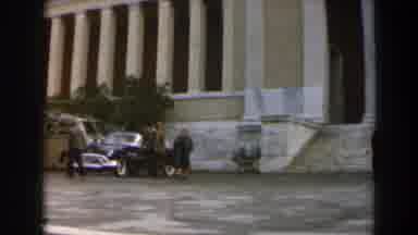 Israel (1960): Two Man Walking Away From A Large Building With A Parked Car In