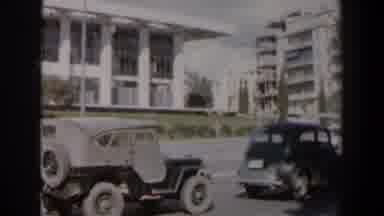 Israel (1960): Two Cars Parked In Front Of White Building On A Bright Sunny Day