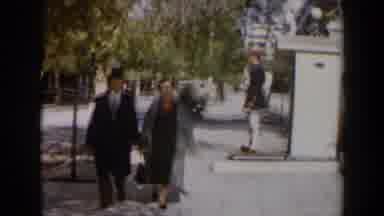 Israel (1960): Elderly Couple Walks Past Green Tree While Black Drives Away On A