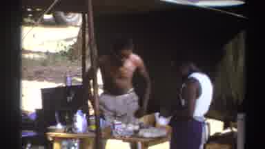 South Africa (1969): An African Man Helping His Woman With Chores After Cooking