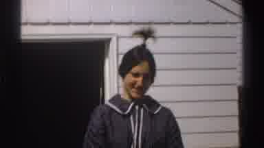 Michigan-1969: Woman With Ponytail Standing and Smiling in Front of House