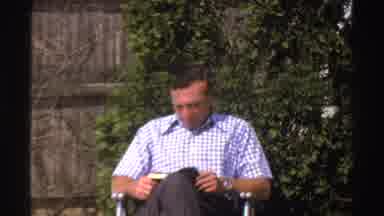 Michigan (1969): Dad Reading A Book And Sitting In A Chair In The Yard