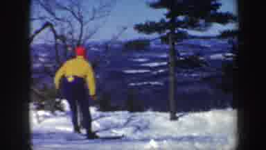 Vermont (1962): Female With Yellow Jacket Skiing Down A Hill In The Winter