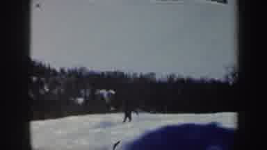Vermont (1962): Two People Skiing Together Near Mountains And Forest Area