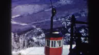 Vermont (1962): A Red Cable Car With Windows Travels Up A Snow Covered Mountain