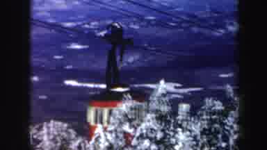 Vermont (1962): A Red Cable Car Passes Through Snow Covered Conifer Trees Followed