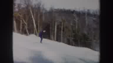 Vermont (1962): A Person In A Blue Suit And White Cap Skiing On A Snow Mountain