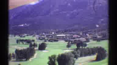 Colorado (1969): View Of Green Grass Trees And Mountain Base On A Clear Day