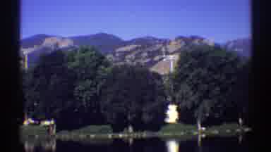 Colorado (1969): A Big Blue Lake Surrounded By A Forest With Many Trees And
