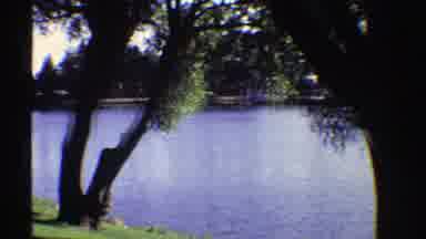 Colorado (1969): A Cool View Of A Calm Lake Surrounded By Trees And Buildings At