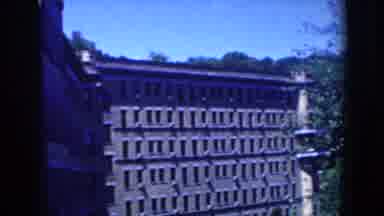 French Lick Indiana-1958: View Of Large Brick Building With Many Windows And Tree-Covered Hills