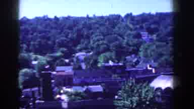 French Lick Indiana (1958): View Of Green Trees And Brown Building On A Sunny Day