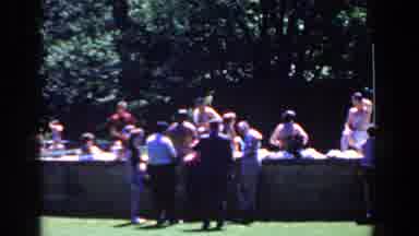 French Lick Indiana (1958): People Sitting Together In A Grassy Park With Bathing
