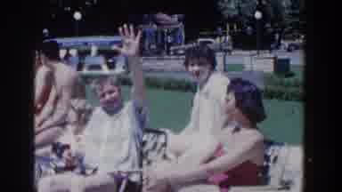 French Lick Indiana (1958): Young People Sit On A Lawn In The Sun In Front Of A