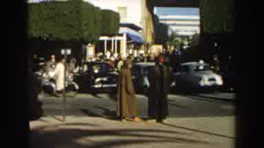 Casablanca (1959): Two Guys With Long Clothes Are Chatting Beside The Street With