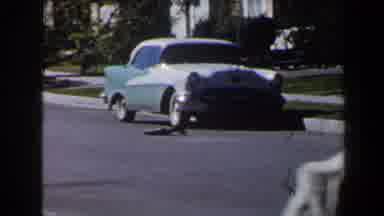 Las Vegas-1958: Toddler in White Coat Walks on Lawn Near Vintage Car