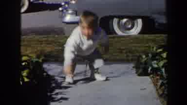 Las Vegas (1958): Young Child Dressed In White Walks Around Front Yard With Cars