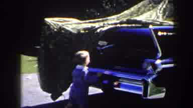 Las Vegas (1958): Toddler Wearing Blue Suit Looks At Blue Car On A Sunny Day