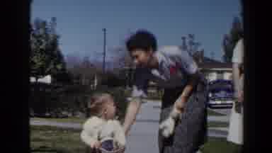 Las Vegas (1958): Woman Wearing Blue Shirt Helps Toddler Wearing White Shirt Sit