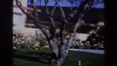 Las Vegas (1958): Woman In Red Walks Outside Carrying Bags