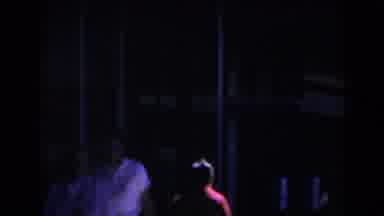 Las Vegas (1958): Person Wearing Red Coat Walks To Entrance Of White Building On A