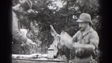 Chelan Washington-1939: Hunting Men Skinning Deer in Woods Joking and Chanting