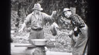 Chelan Washington (1939): A Hillbilly Cranks A Meat Grinder On A Fallen Log While