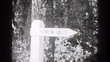 Chelan Washington (1939): A Black Cat Walks Across The Ground And A Man Carrying A