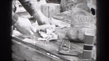 Chelan Washington (1939): Person Cuts Meat On Cutting Board To Put In Silver Meat