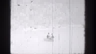 Chelan Washington (1939): Two People Row A Small Boat On A Medium-Sized Lake