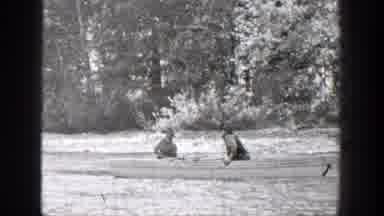 Chelan Washington (1939): Two People Riding A Canoe Down A River