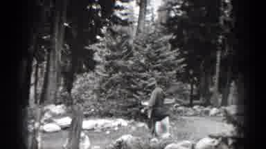 Chelan Washington (1939): Person Wearing Grey Hat Carries Large White Bag And View