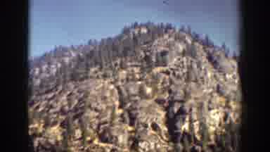 Chelan Washington (1939): A Big Blue Lake Surrounded By Mountains And Many Trees