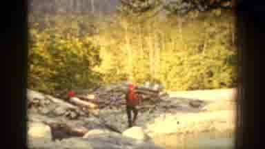 Chelan Washington (1939): Men Walking Near A River And One Man Runs Across The
