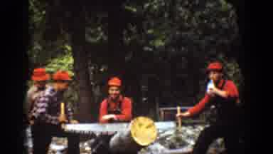 Chelan Washington (1939): Two Men Wearing Red Hats Cut Log With Large Crosscut Saw