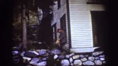 Chelan Washington (1939): Man Wearing Grey Jacket Walks Past White Building On A