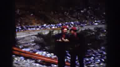 Chelan Washington (1939): Two Men Wearing Matching Outfits Playfully Fighting Each