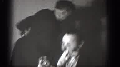 Chelan Washington (1939): Man Wearing Glasses Eats Turkey Leg While Two Men Sheila