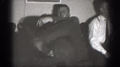 Chelan Washington (1939): Person Wearing Black Shirt Lifts Man Wearing Grey Shirt