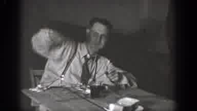 Chelan Washington (1939): Man Wearing Grey Tie Points At Man Wearing Glasses