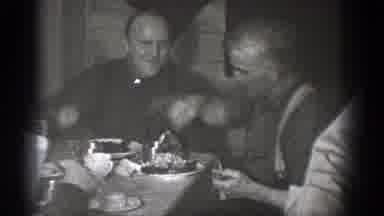 Chelan Washington (1939): Man Wearing Dark Grey Shirt Points At Camera With Eating