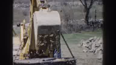 Nebraska-1959: Man Operating Tractor Lifting Concrete Block