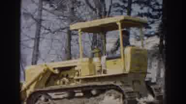 Nebraska (1959): Man Operating Tractor On Terrain With Some Leafless Trees Around